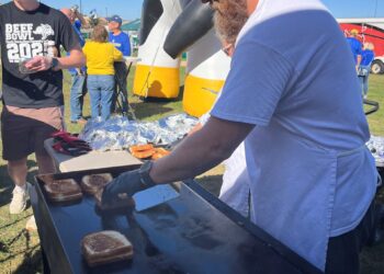 Jon Rogers of Valley Queen Cheese flipping sandwiches