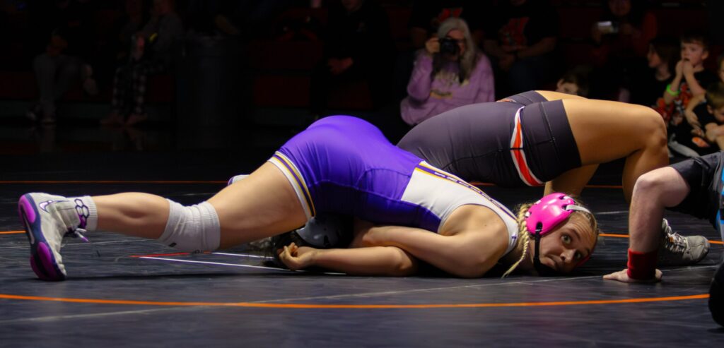 Brooke Grajczyk of Watertown pins her opponent from Huron