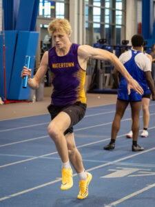 Luke McLaughlin after receiving the baton from Gavin Robison not pictured