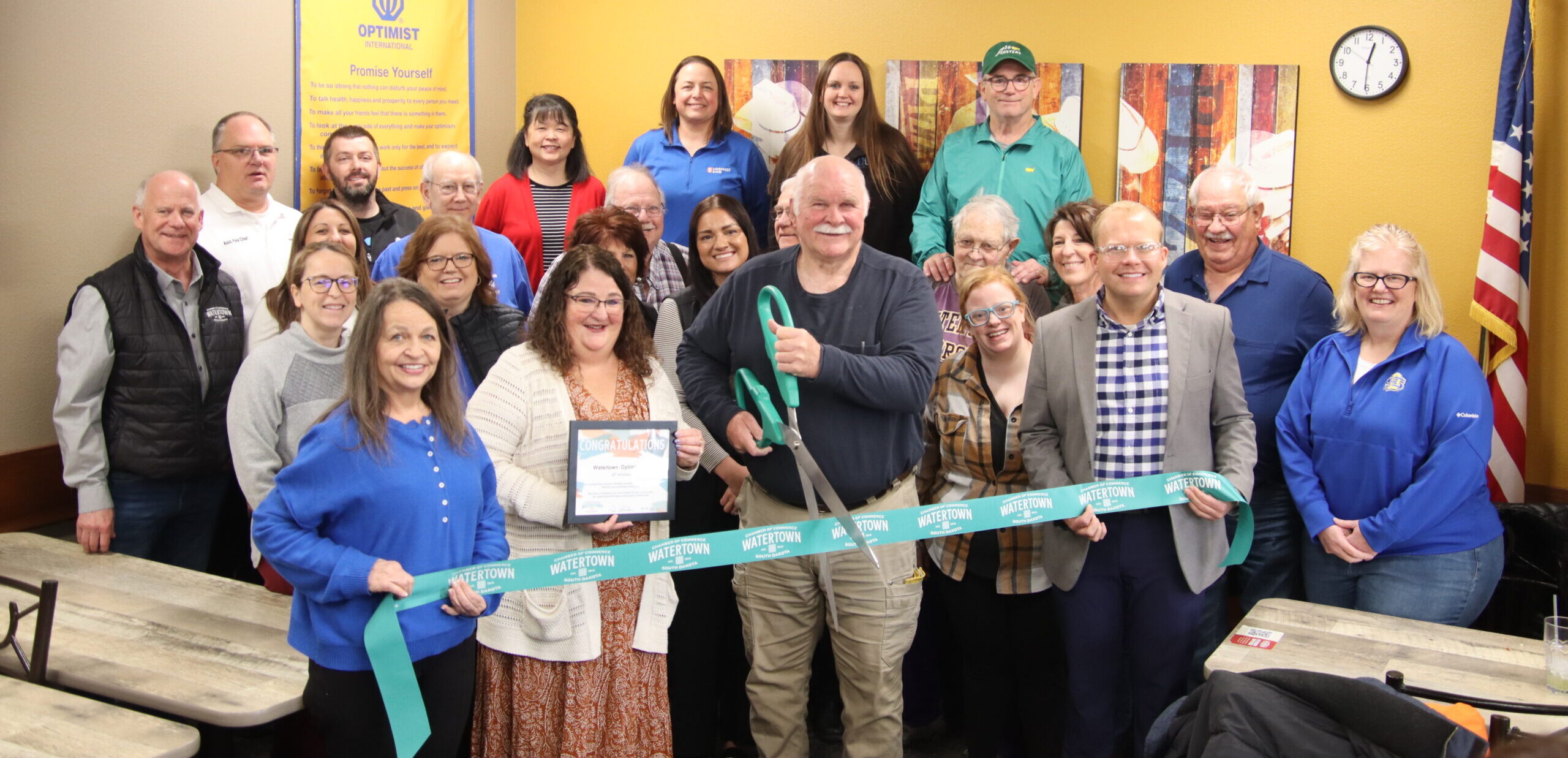 Randy Rakness, a 50-year member, and other Optimists pose before cutting the ribbon. Photo by Tucker Hermans.