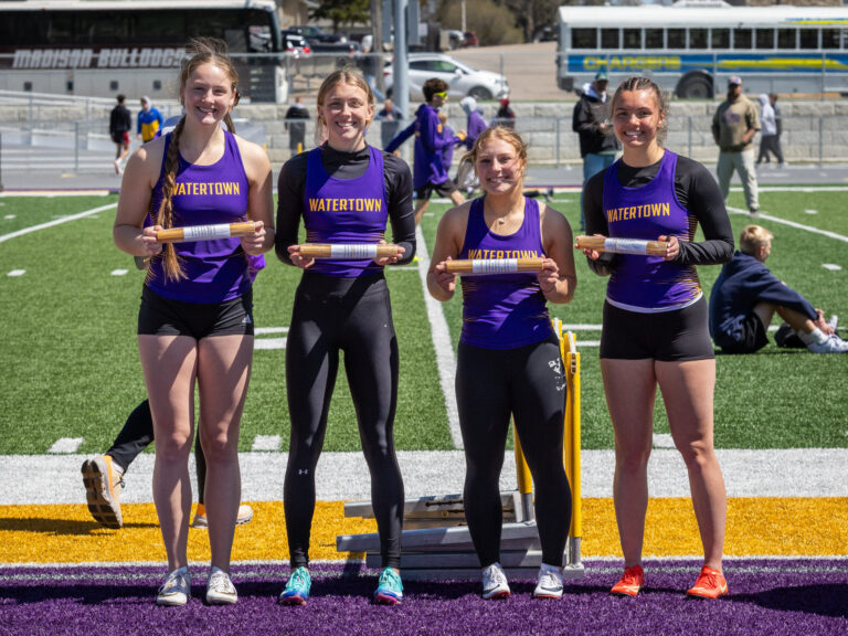 The Watertown girls 4x100 received batons for winning their relay. Pictured from left to right Carighan Klatt Anna Hirtz Ashlynn Andrews and Alayna Smith