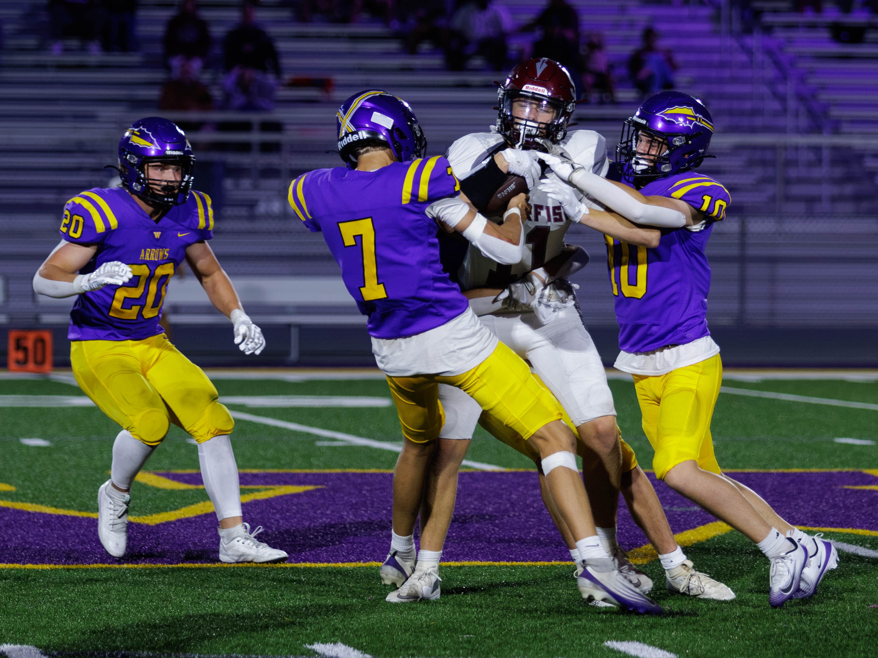 Kutler Swenson 7 and Caden Corey 10 attempt to strip the ball from the Spearfish player