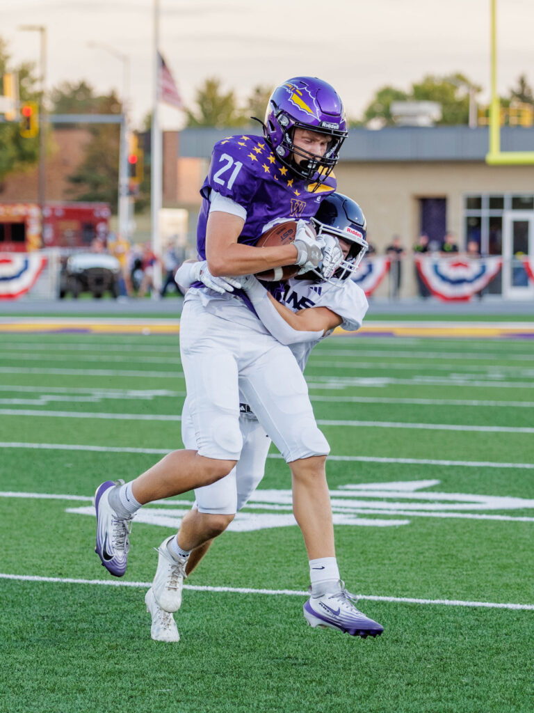Kye Paulson catches the ball and gets tackled